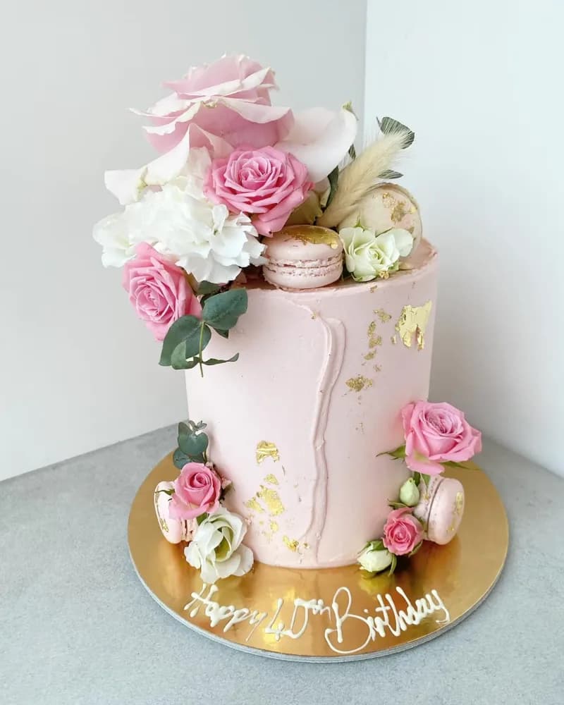 Pink 40th birthday cake with roses and gold leaf