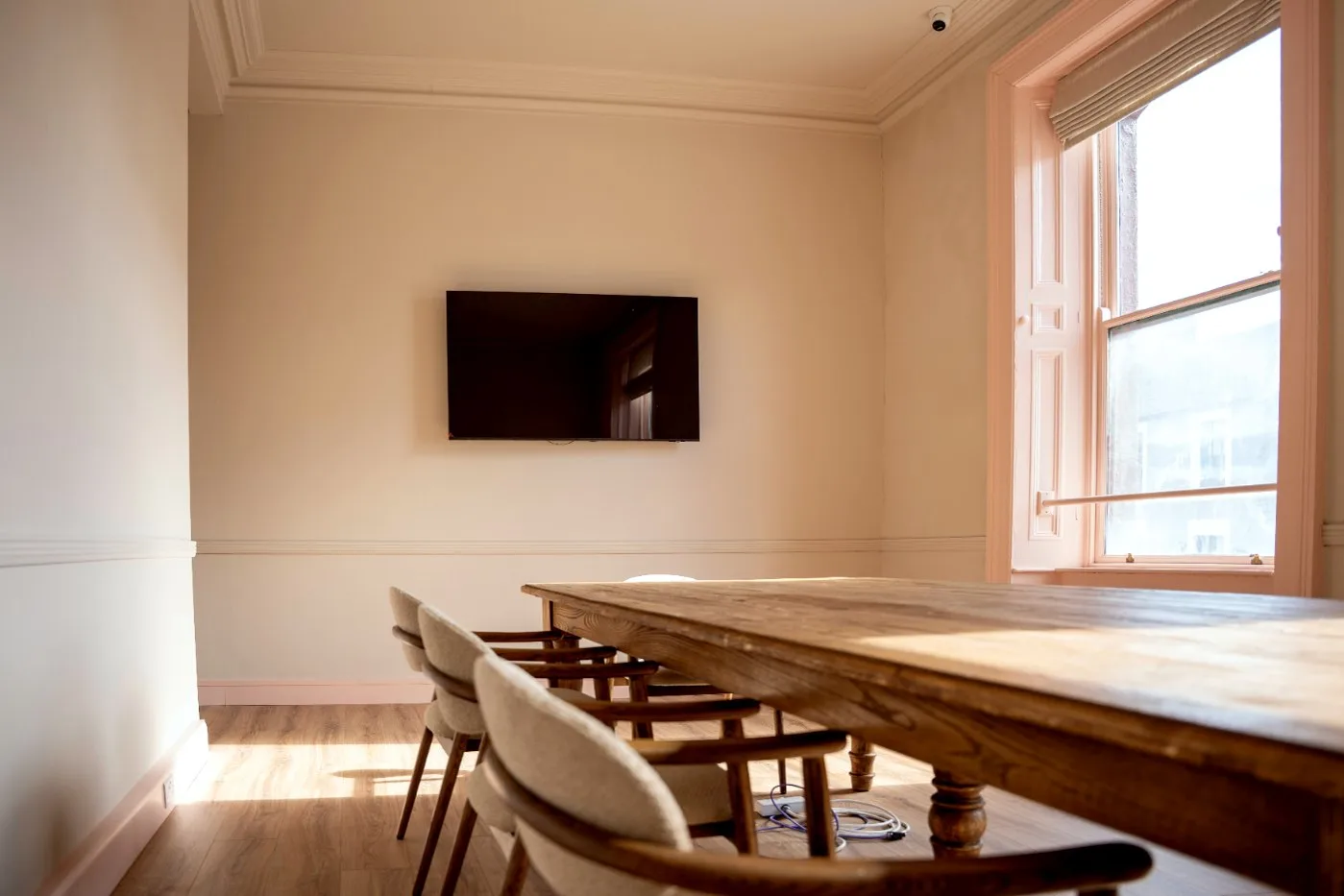 The Bank Room: a long oak table, a screen and tall windows
