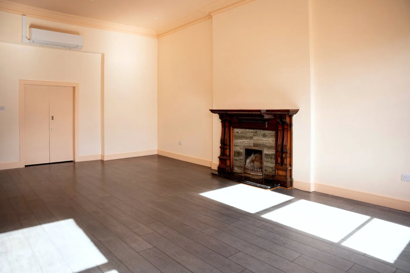 One of the Square Offices: sunlight on the floor and a fireplace